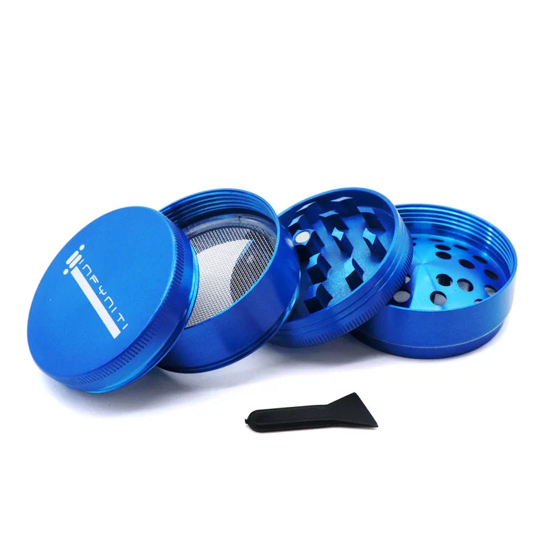Blue Infyniti 50mm grinder opened into separate sections with its small scraper beside it