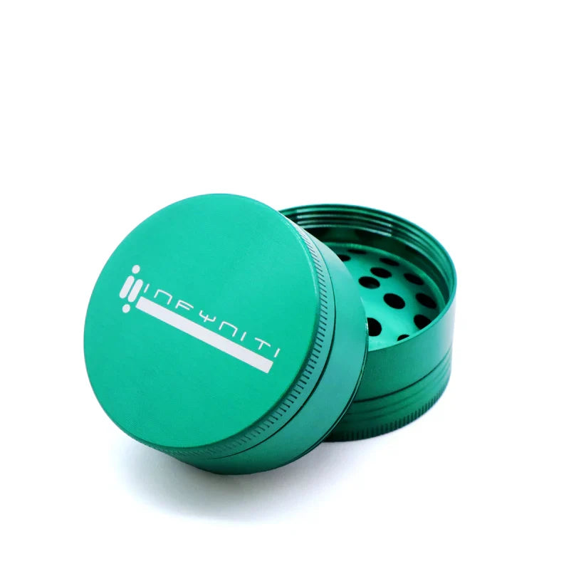 Green Infyniti 50mm four-piece grinder with the logo lid tilted to show the cutting teeth