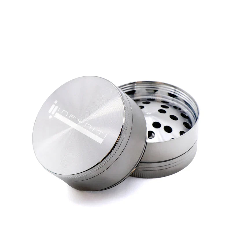 White Nickel Infyniti 50mm grinder showing its silver-coloured lid and open grinding section