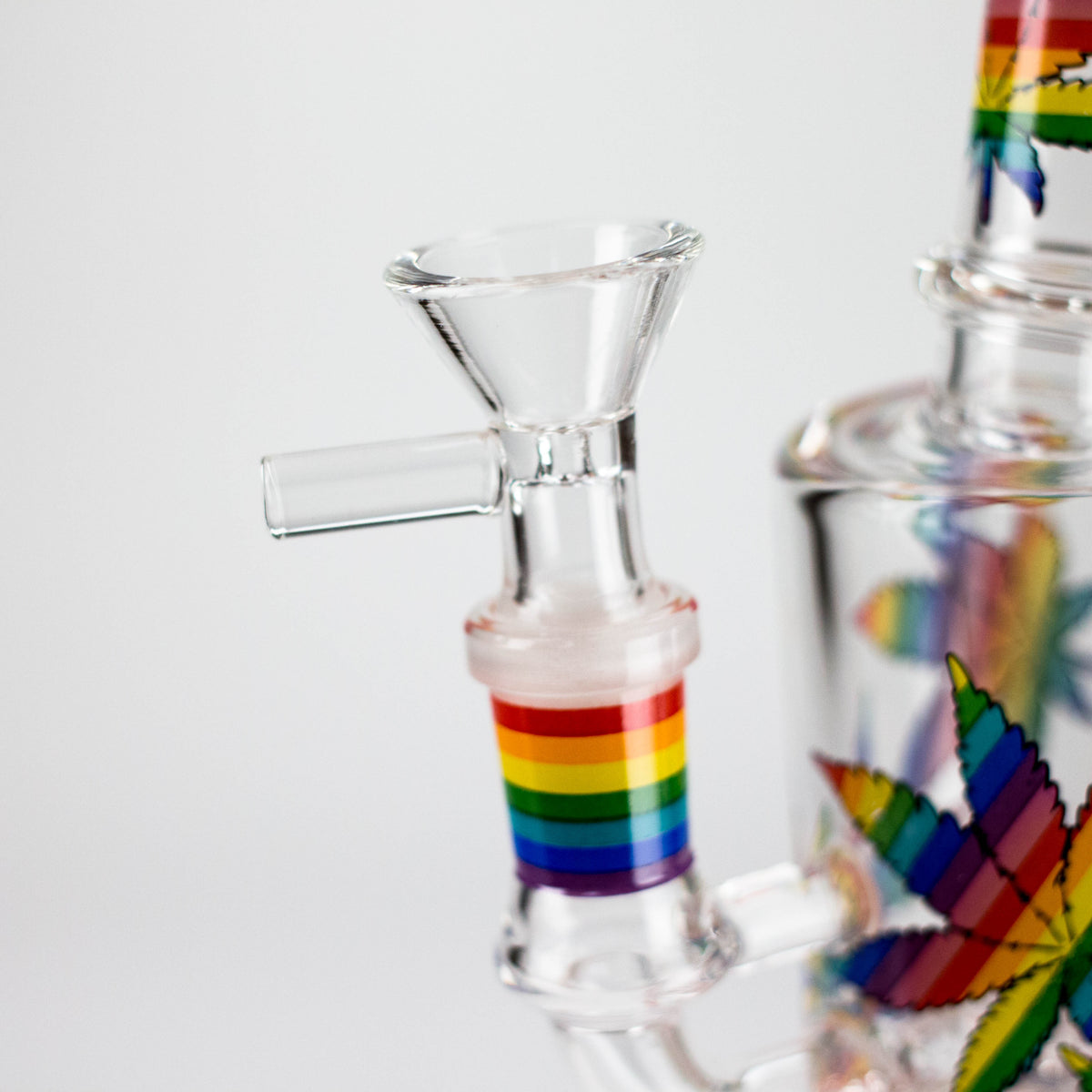 Close-up of the handled herb bowl in the leaf print rig rainbow-striped glass joint