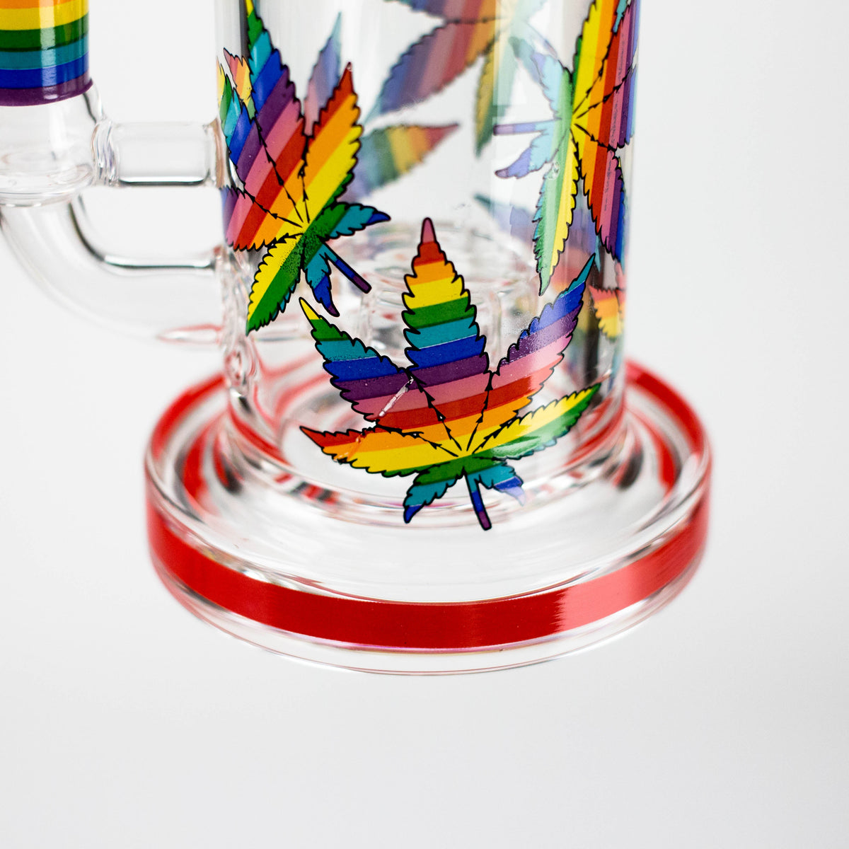 Close-up of rainbow leaf graphics around the glass chamber and red base trim