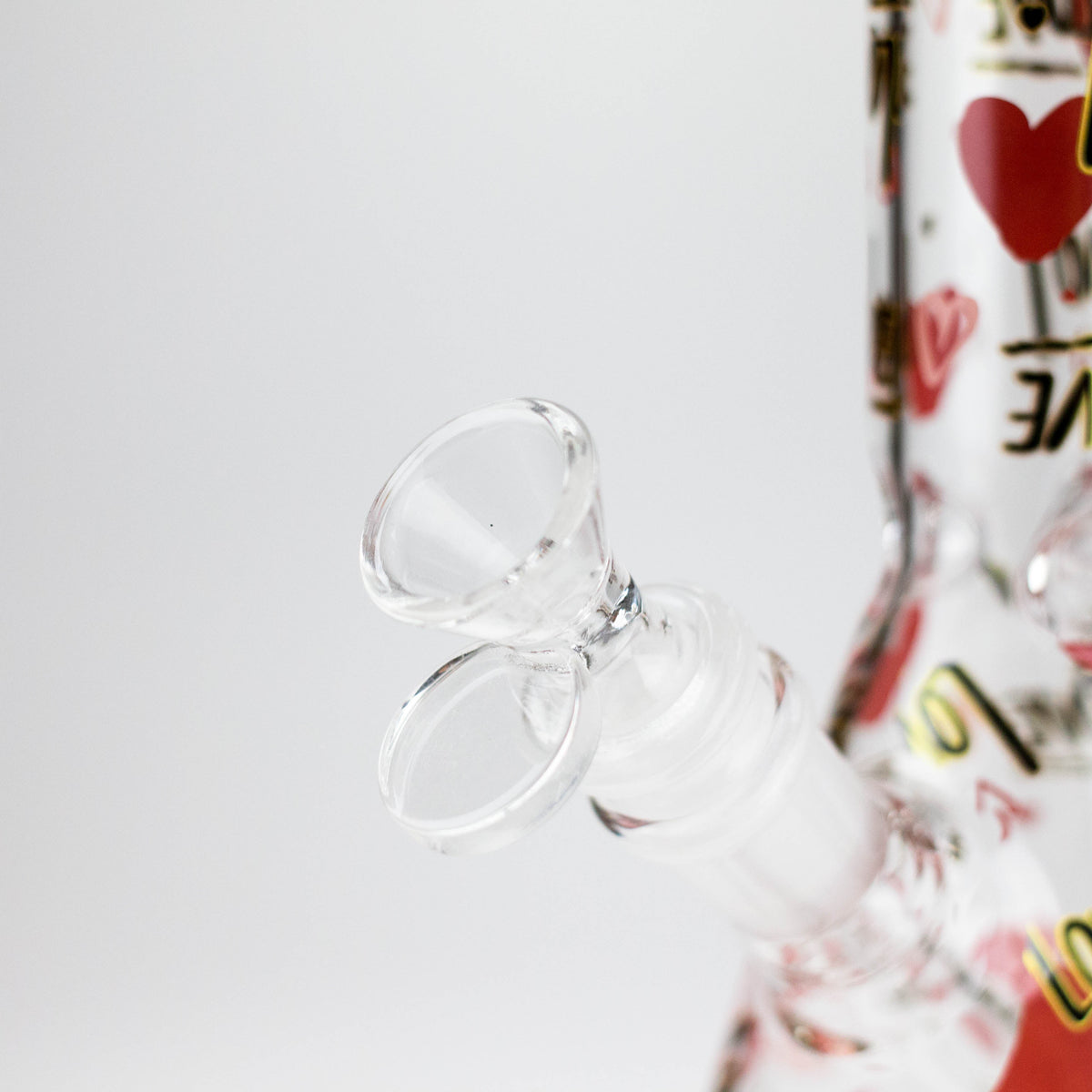 Close-up of the clear glass bowl with loop handle and ground-glass joint on the Love beaker