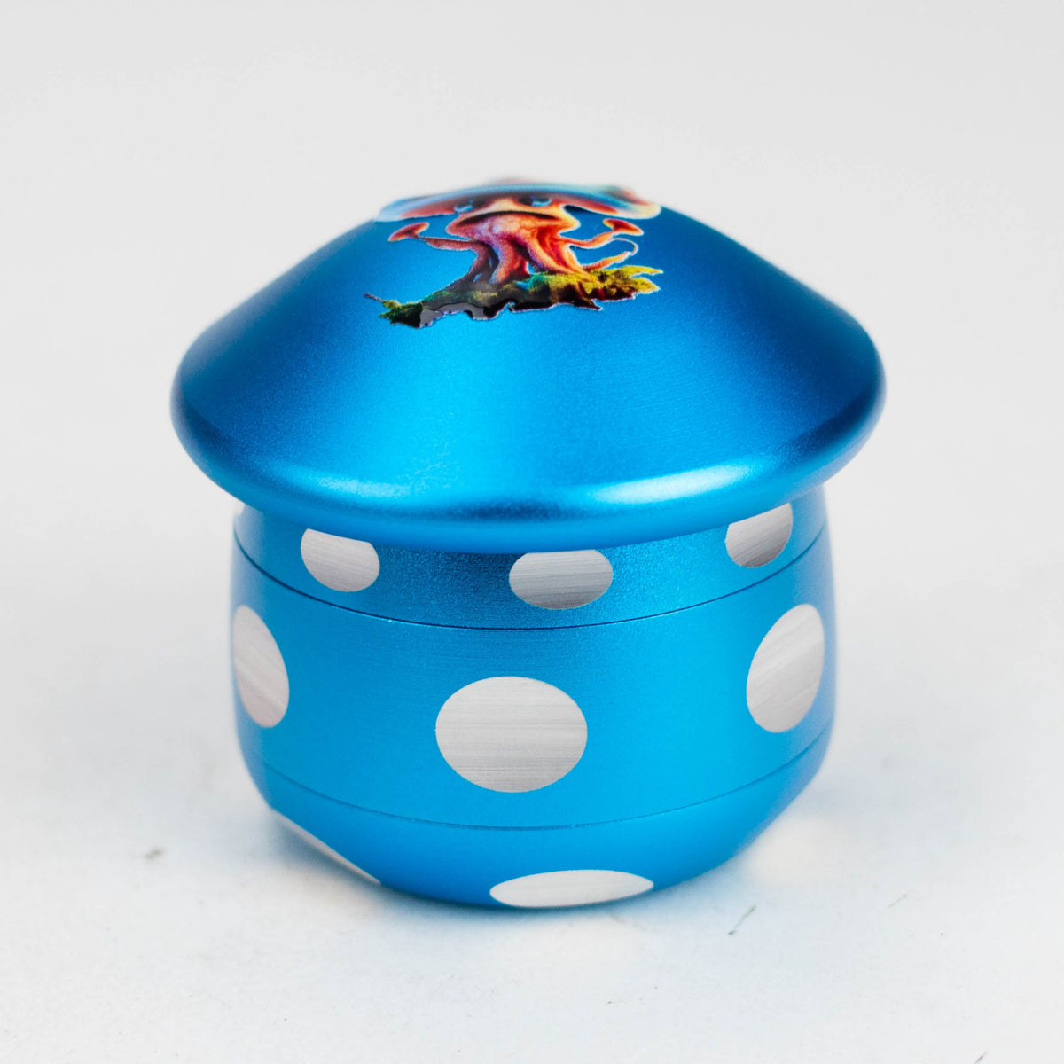 Blue mushroom-shaped four-piece herb grinder with white spots and blue cap artwork