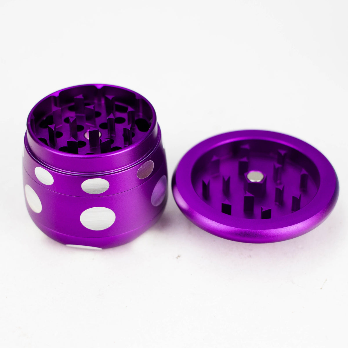 Purple mushroom grinder with its cap removed showing the cutting teeth in both halves