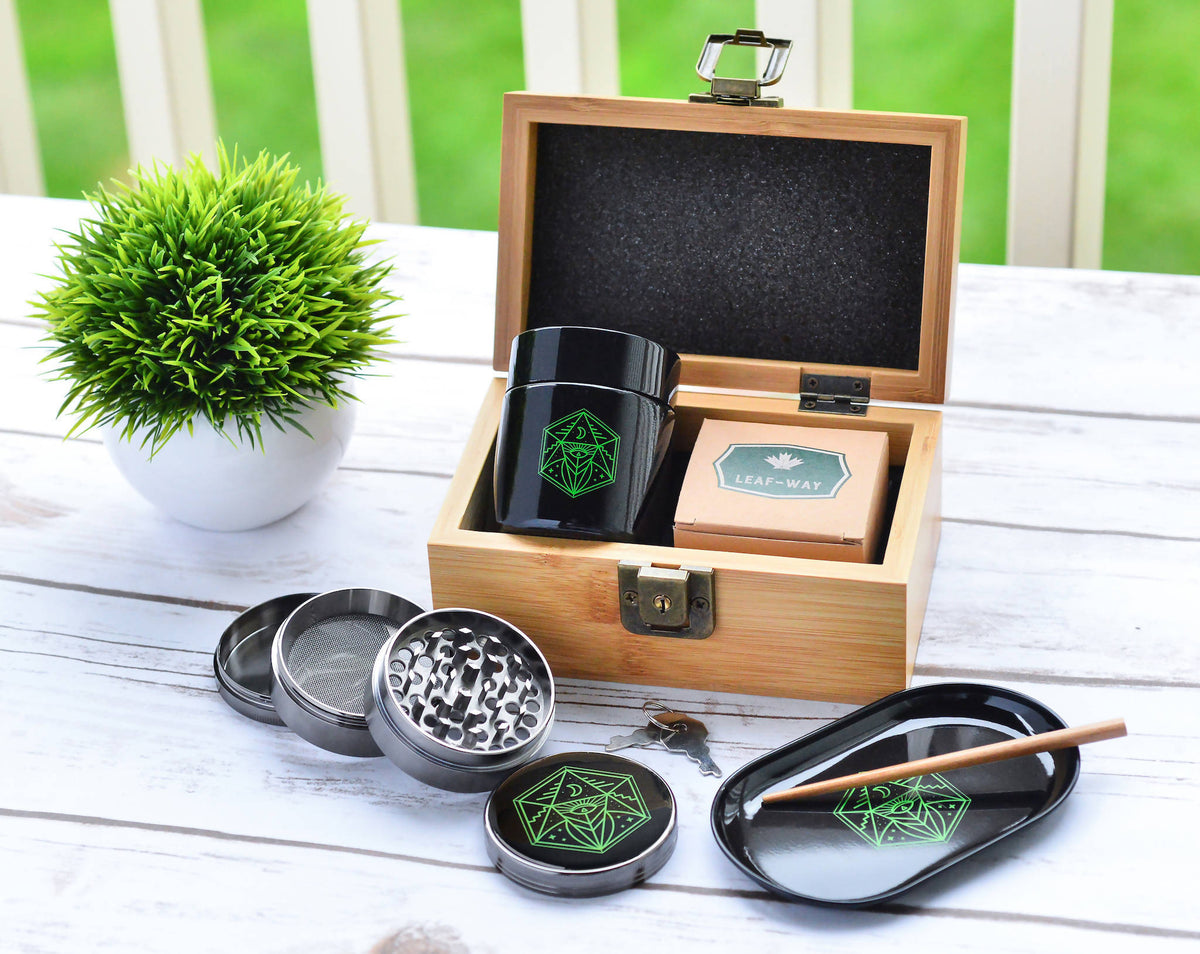 Stash Box with keys, grinder, metal rolling tray, and glass stash jar for cannabis