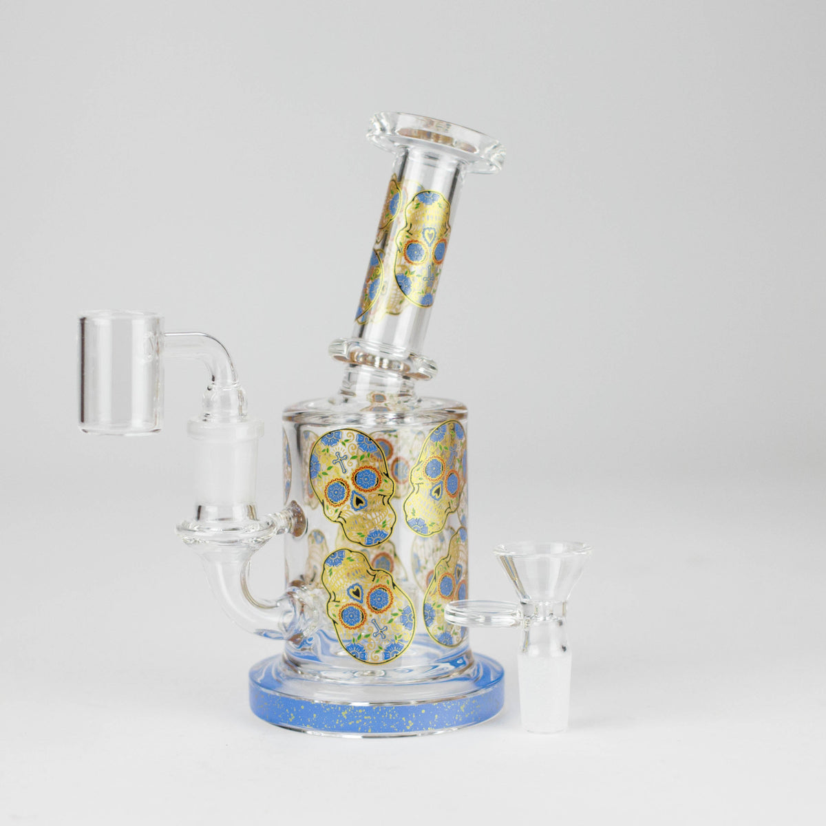Blue-base sugar skull hybrid glass rig shown with its banger and separate herb bowl