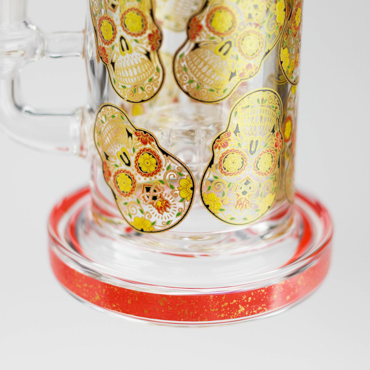 Decorated sugar skull graphics on the glass chamber above a red-trim round base