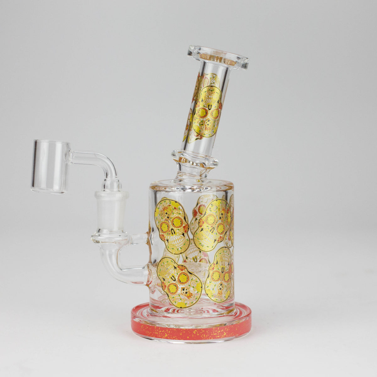 Red-trim sugar skull glass rig with banger installed, angled neck and round base