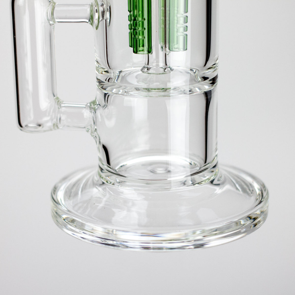 Close-up of the Triangle rig’s round glass base and Green percolator assembly