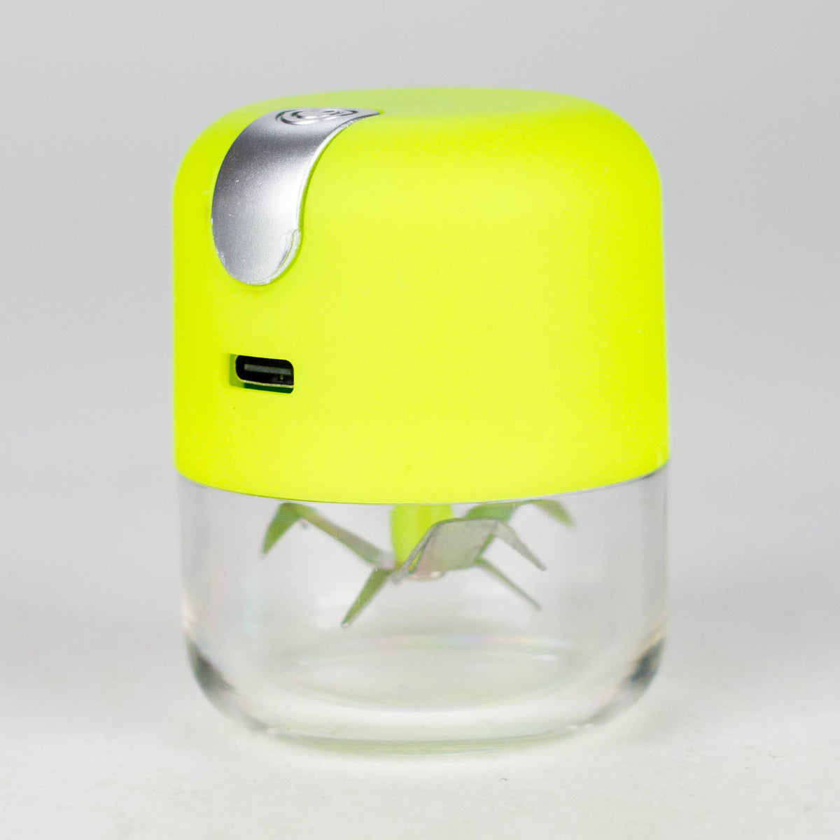 Apple Green electric herb grinder with a yellow-green metal body, USB port and transparent grinding chamber