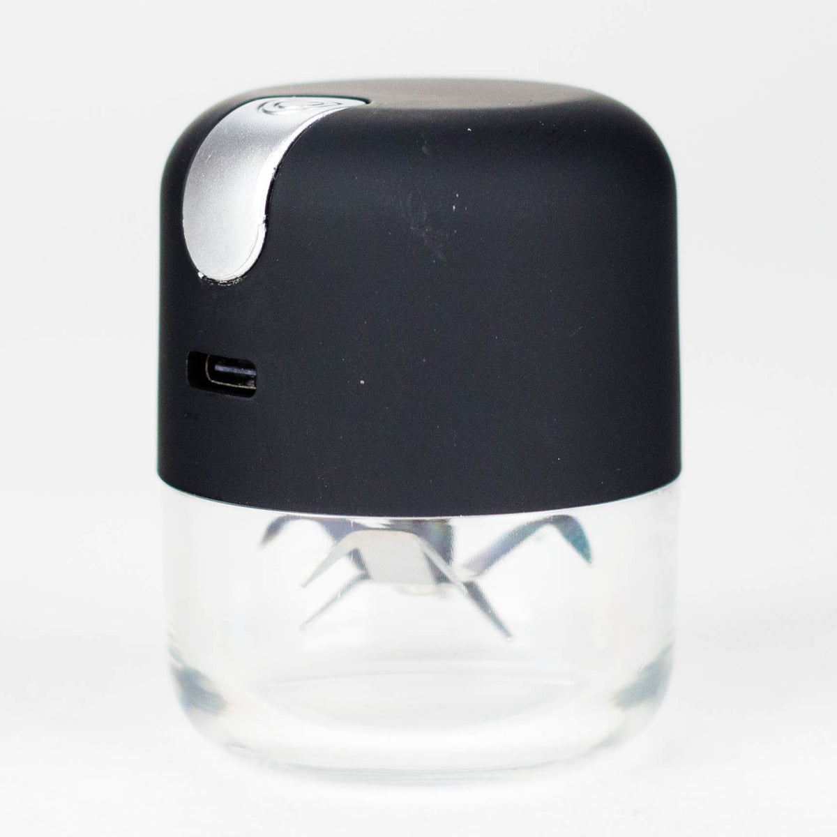 Black electric metal grinder showing its silver button and transparent lower chamber