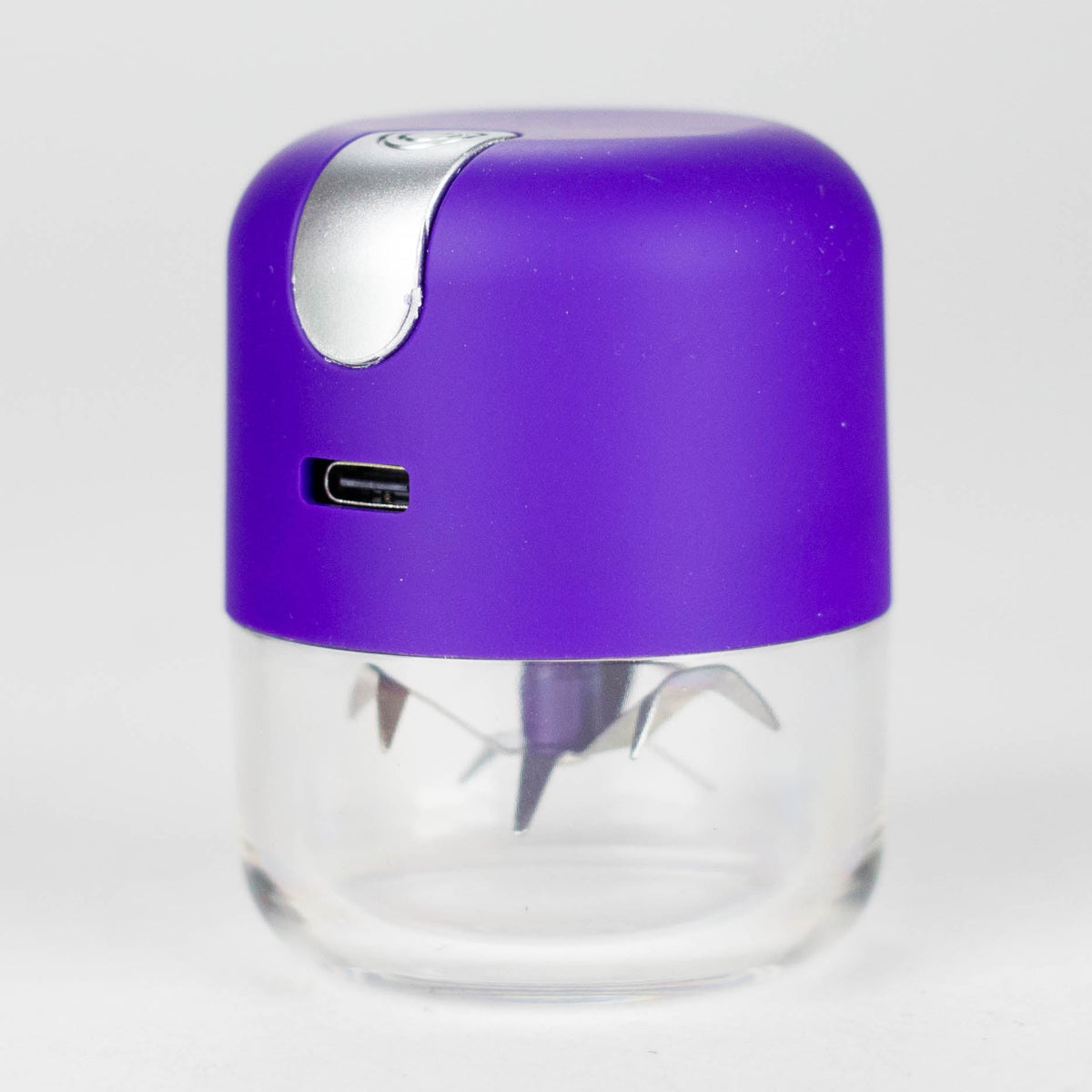 Purple USB rechargeable metal grinder with a silver button and cutting blades visible through its clear chamber